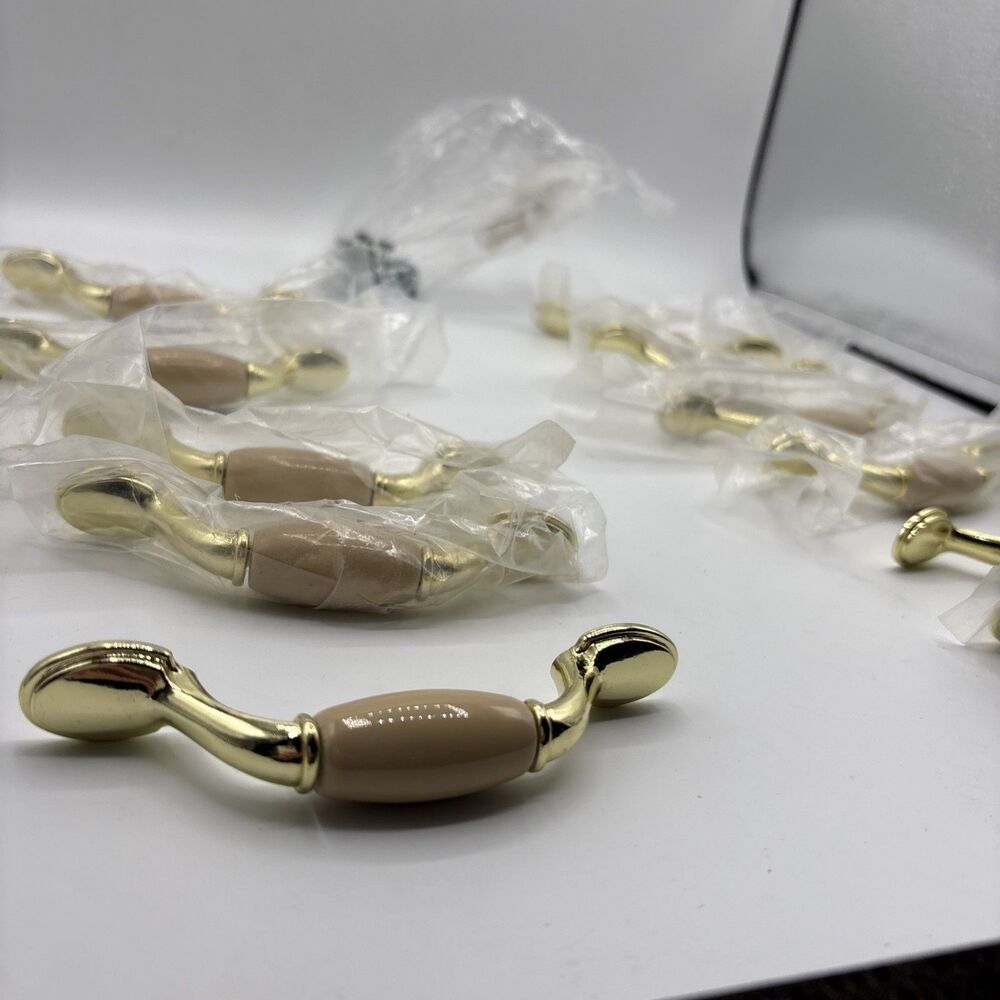 11 almond ceramic and polished Gold spoon foot cabinet pull with 3-inch Center-C